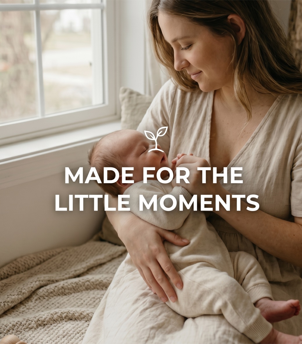 A mother holding her sleeping newborn by a sunlit window